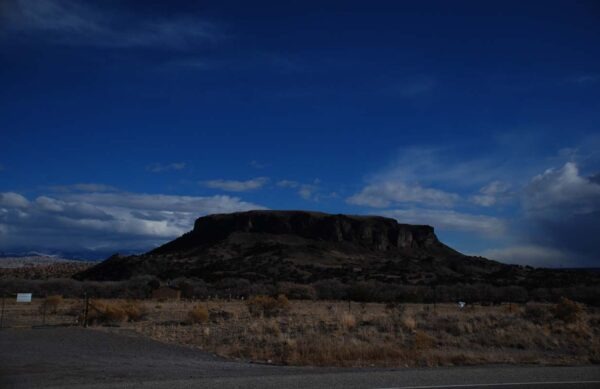 Prominent flat-topped mesa under a blue sky