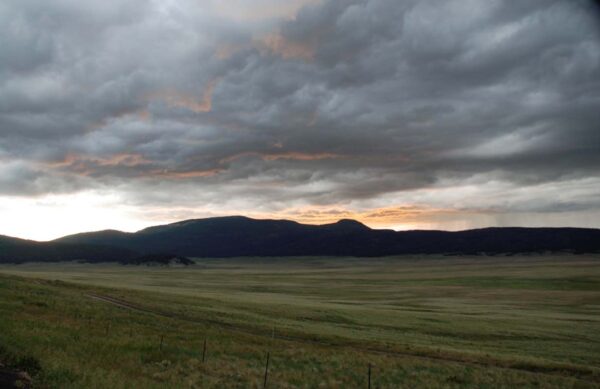 Dramatic clouds loom over a vast