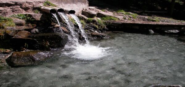 A serene waterfall cascades down rocky terrain