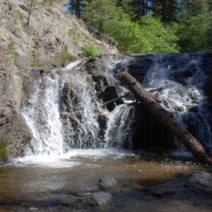 A serene waterfall cascades down rocky terrain